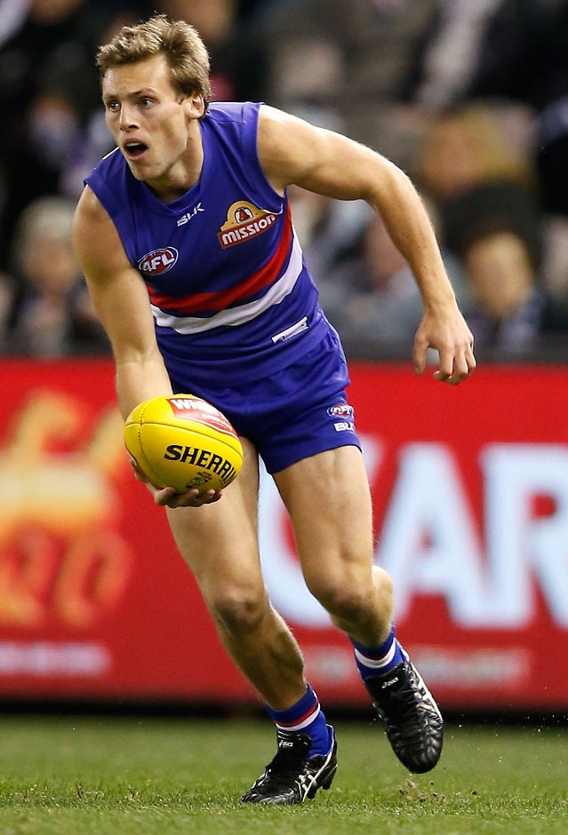 AFL 2015 Rd 17 - Western Bulldogs v Collingwood MELBOURNE, AUSTRALIA - JULY 26: Josh Prudden of the Bulldogs handpasses the ball during the 2015 AFL round 17 match between the Western Bulldogs and the Collingwood Magpies at Etihad Stadium, Melbourne, Australia on July 26, 2015. (Photo by Adam Trafford/AFL Media)